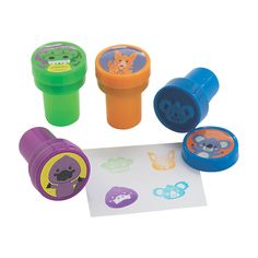 three rubber stamps with animals on them sitting next to a piece of paper and some stickers