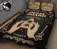 a bed with a black comforter and some pictures on the wall