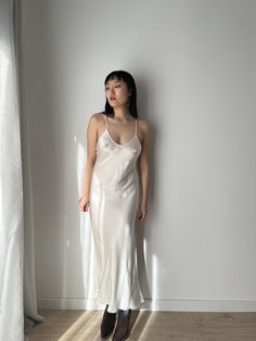 Vintage liquid silk satin backless white slip long maxi camisole dress with lace back cross design, you can wear it as a summer silk slip dress or night party dress.  era: 1990, 2000, Y2K material:100% pure silk Size: around S, Model wears size S, 36 Full length 125cm pit to pit: 36cm waist: 35cm condition: very good condition Please keep in mind that this is vintage second hand piece. It may have small marks and/or snags and sign of wear throughout. Please purchase willing to accept all signs o White Satin Backless Slip Dress, Backless Satin Slip Dress For Night, White Backless Bias Cut Maxi Dress, Satin Camisole Slip Dress For Wedding Night, White Satin Slip Dress For Wedding Night, Satin Slip Dress With Bias Cut For Night, Bias Cut Satin Slip Dress For Night, White Silk Camisole Slip Dress, Silk Cami Slip Dress With Bias Cut