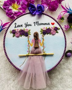 a girl on a swing with flowers around her and the words love you mumma