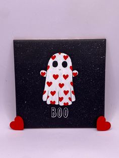 a black and white sign with red hearts on it that has a ghost in the center