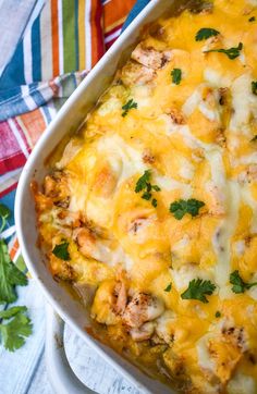 a casserole dish with chicken, cheese and parsley