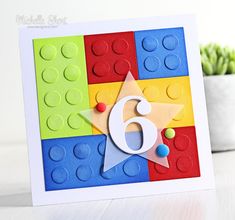 a close up of a card with a number six on it and a lego background