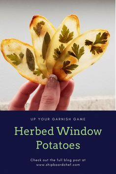 a hand holding up a piece of bread with leaves on it and the words herb window potatoes