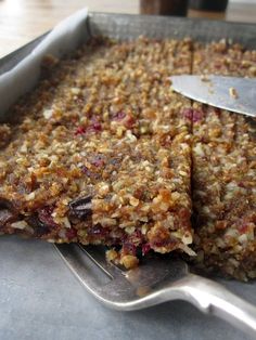 a close up of food on a pan with a knife