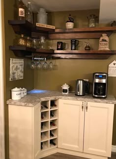 a coffee bar with wine glasses on the shelves