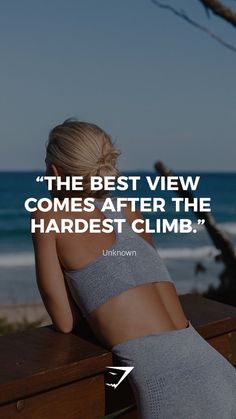 a woman sitting on top of a wooden bench next to the ocean with a quote above her