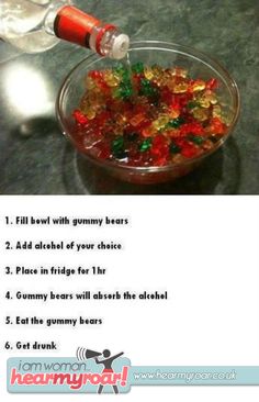 a glass bowl filled with gummy bears next to a bottle