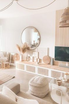 a living room filled with furniture and a flat screen tv mounted on a wall next to a window