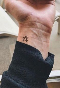 a person with a small tattoo on their wrist that reads, twenty four forty five