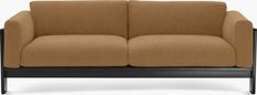 a brown couch sitting on top of a wooden frame