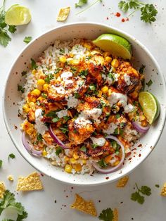 a bowl filled with rice, corn and cilantro on top of a table