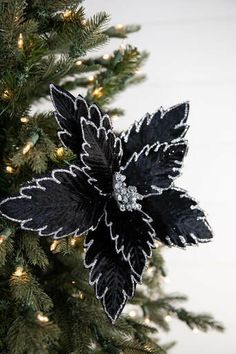 a black and white flower on top of a christmas tree