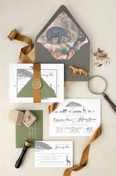 the wedding stationery is laid out on top of each other, including an envelope and stamps