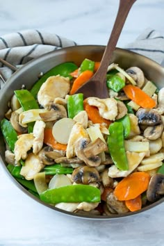 a pan filled with stir fry vegetables and mushrooms