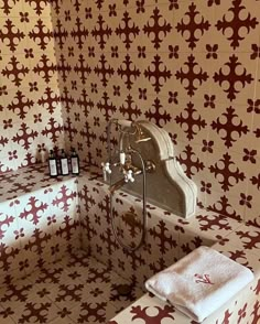 a bathroom with red and white wall paper