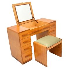 a wooden desk with a mirror and stool