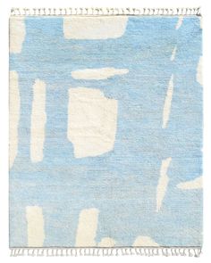 a blue and white rug with fringes on it