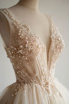 a dress with pearls on it is shown