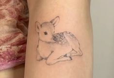 a small tattoo of a baby deer on the right side of the calf's leg