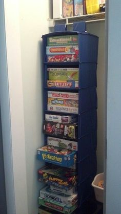 there is a blue tower that has many games on top of it in the corner