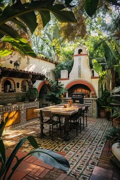 an outdoor dining area with potted plants on the table and oven in the background