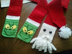 two crocheted christmas stockings with faces on them