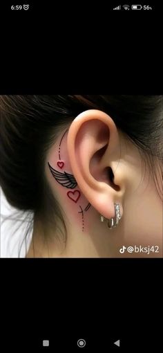 an ear with some tattoos on it