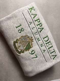 a white towel with green lettering on it