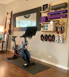 there is a bike and exercise equipment in this home gym area with wood flooring