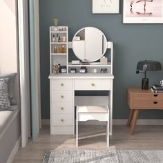 a white desk with a mirror, chair and shelf in front of a window on the wall