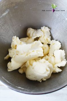 a metal bowl filled with ice cream on top of a table