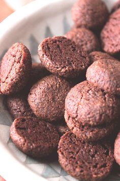 a bowl filled with chocolate cookies on top of a table