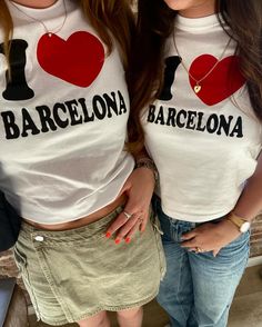 two young women wearing matching shirts with i love barcelona on the front and one in the back