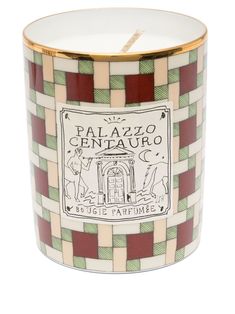 a candle that is sitting on top of a white and green checkerboard pattern