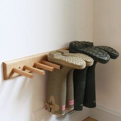 several pairs of shoes are hanging on the wall