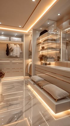 a large walk in closet filled with lots of white furniture and lighting on the walls