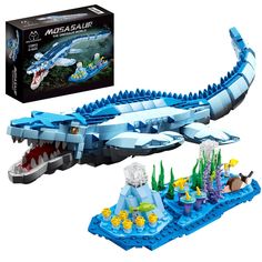 a lego set with an alligator in the water and other toys on display next to it