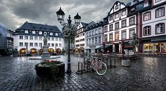 a city square with many buildings and bicycles