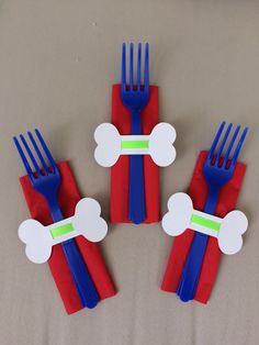 four forks with red, white and blue decorations on them