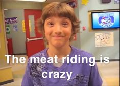 a young boy is smiling and wearing purple in front of a tv screen that says the meat riding is crazy