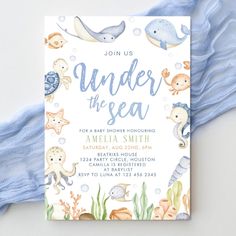 the under the sea baby shower is shown with blue and white watercolors on it