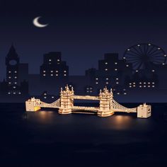 the tower bridge is lit up at night in front of some buildings and a ferris wheel