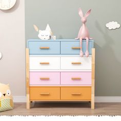 a toy rabbit sitting on top of a colorful dresser