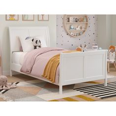 a child's bedroom with white furniture and accessories