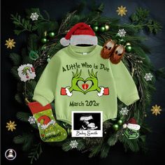 a green christmas sweater with matching socks and booties is featured in the holiday card