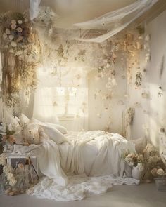 a bed with white sheets and flowers on the wall next to it is covered in sheer curtains