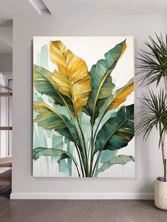 a painting hanging on the wall next to a potted plant in a living room