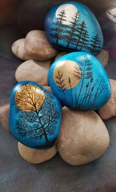 three painted rocks sitting on top of each other