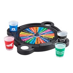 three shot glasses and a wheel of fortune game